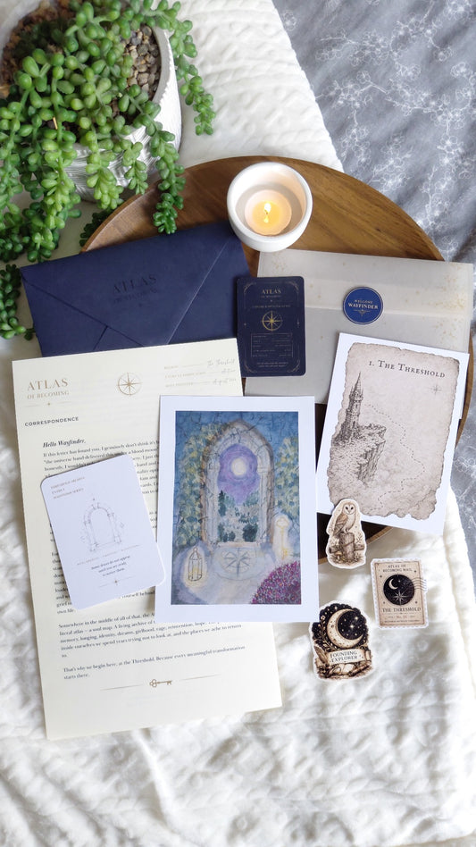 The Threshold Archive Dispatch from Atlas of Becoming, arranged in a blue flat lay